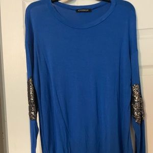 Blue tunic with Black sparkly elbow detail.